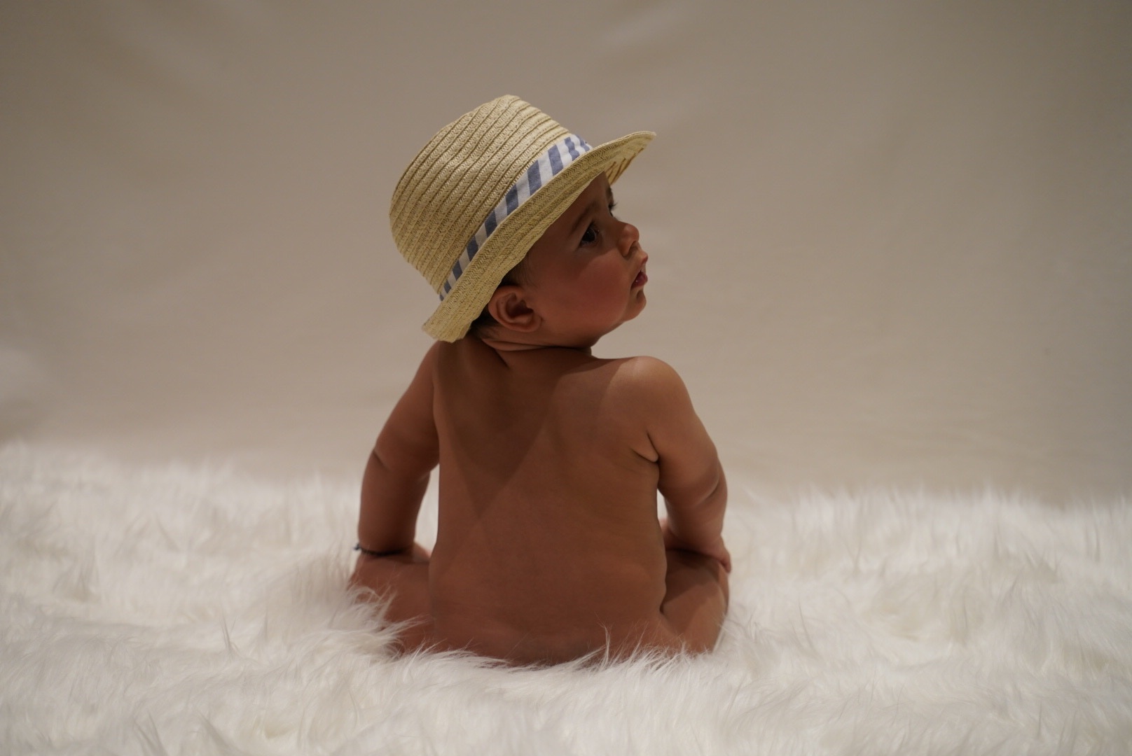 Baby wearing a sun hat during a studio portrait session