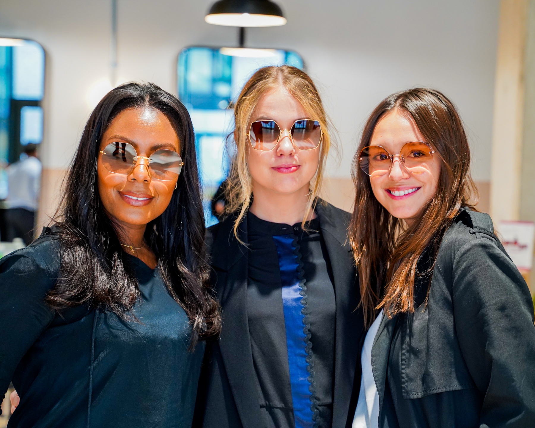Three guests modelling sunglasses at a brand event