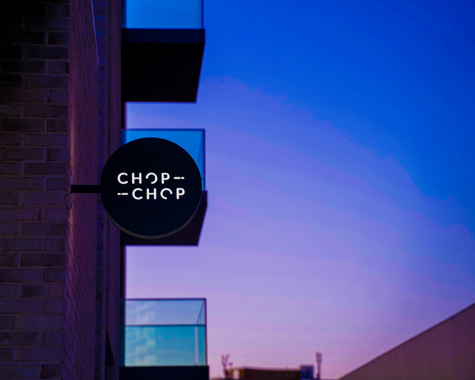 Illuminated Chop Chop hairdresser sign photographed at a UK grand opening