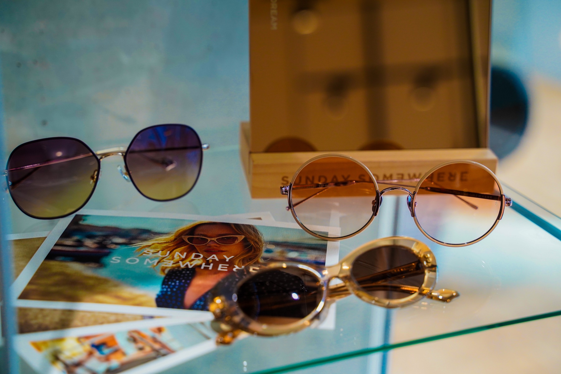 Designer sunglasses arranged with eyewear campaign cards