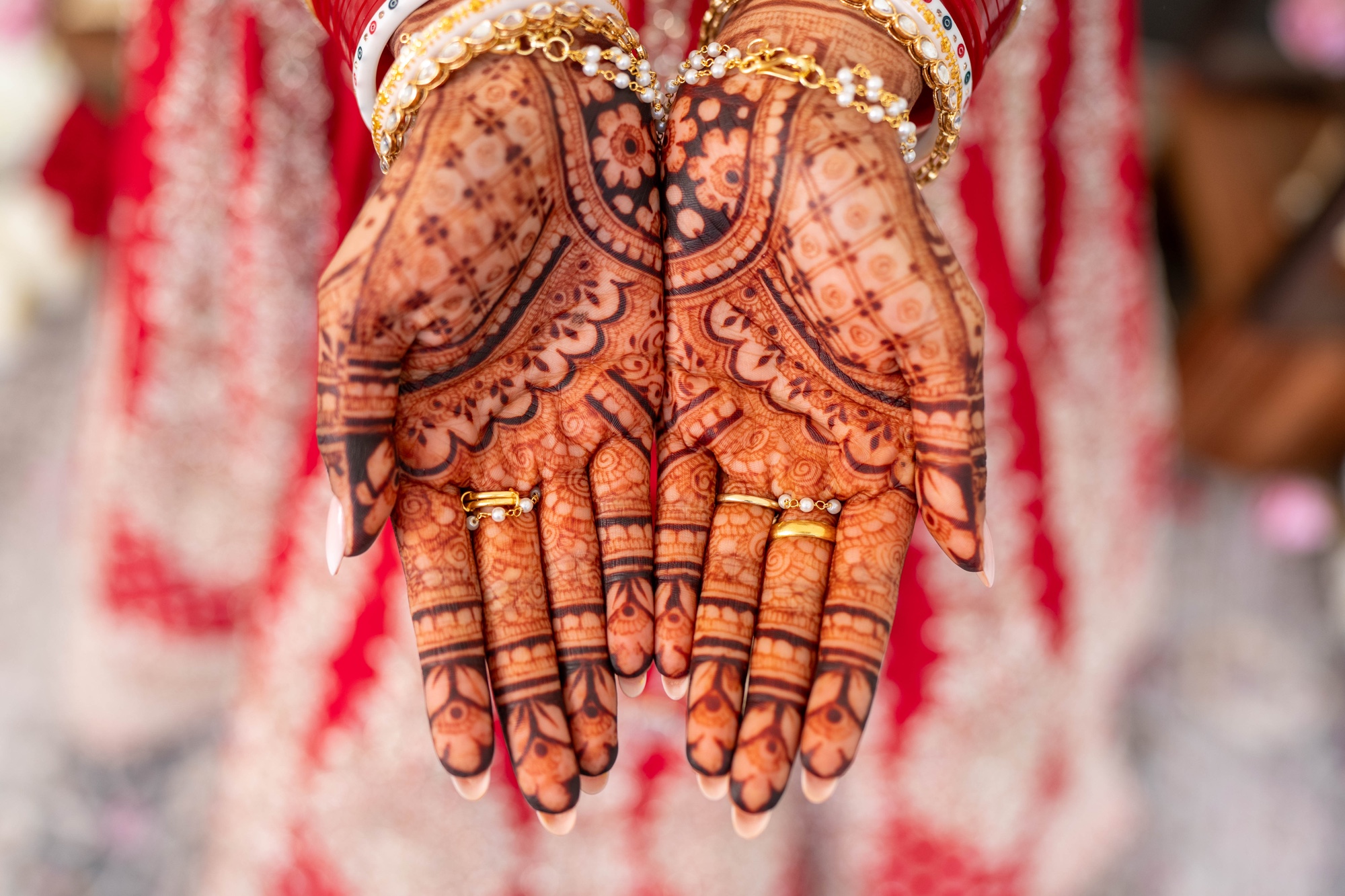 Close-up of a bride's detailed mehndi and wedding jewellery