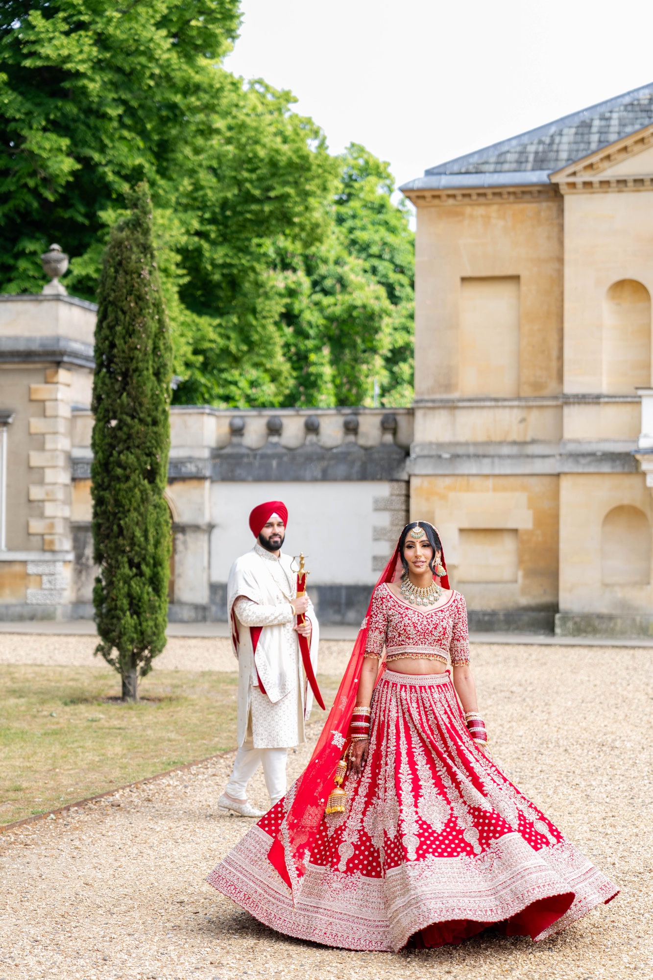 Bride and groom photographed among the gardens of their wedding venue