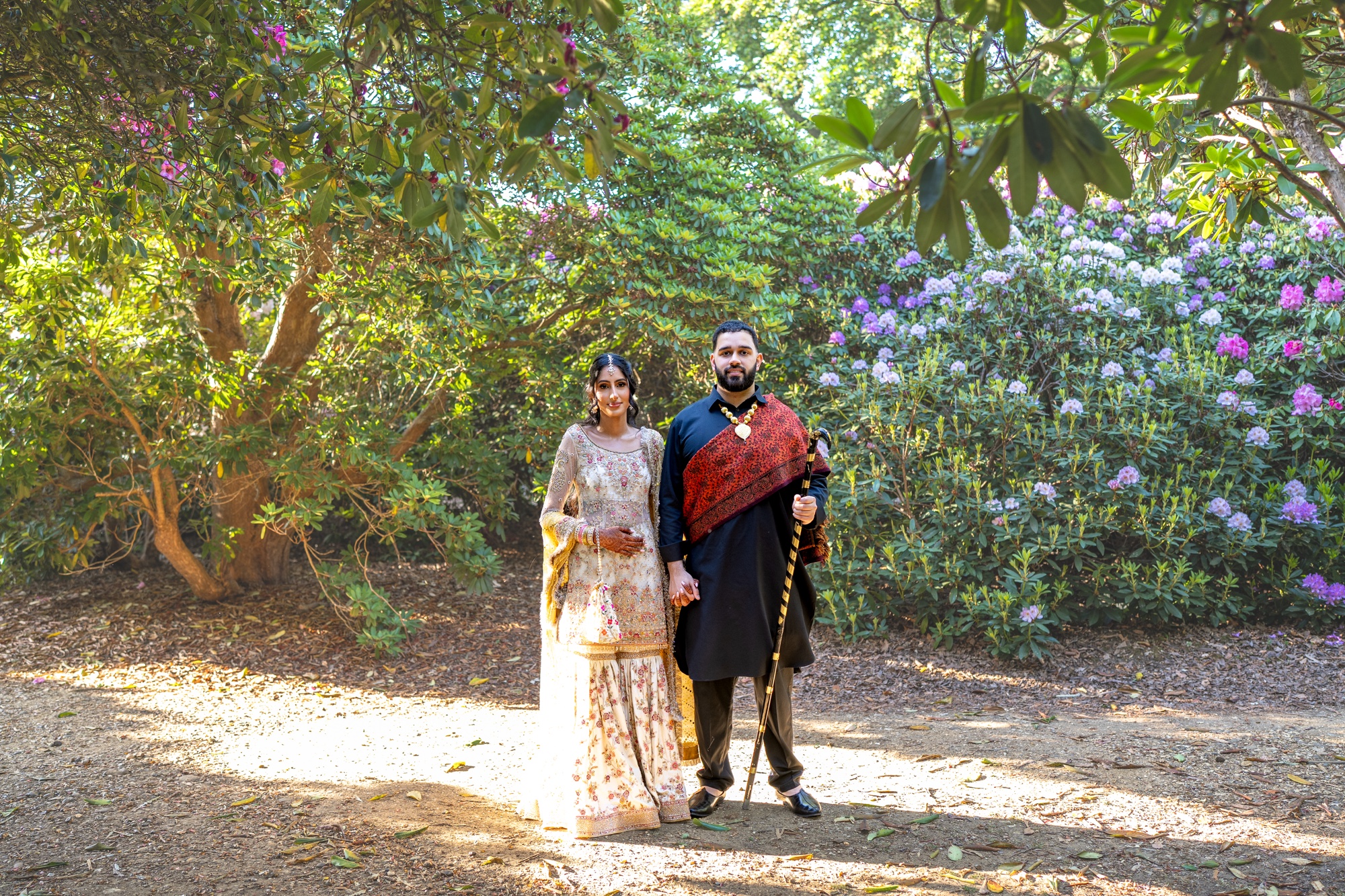 Wedding couple standing together in a flowering garden