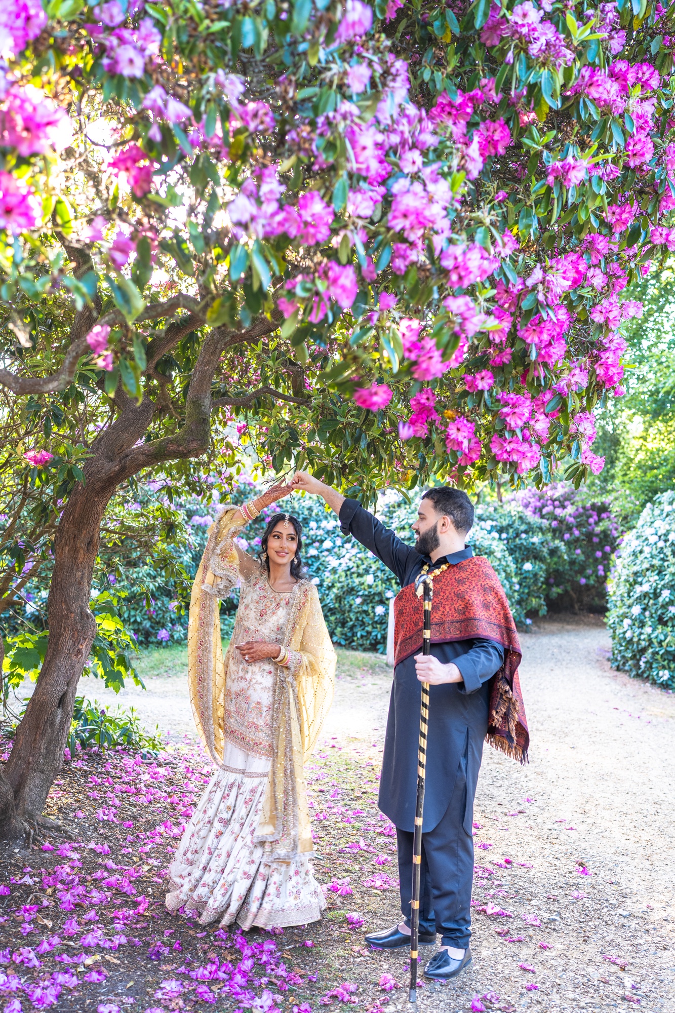 Wedding couple dancing beneath a flowering tree